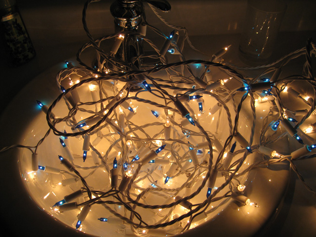 image: blue and white christmas lights in a white sink