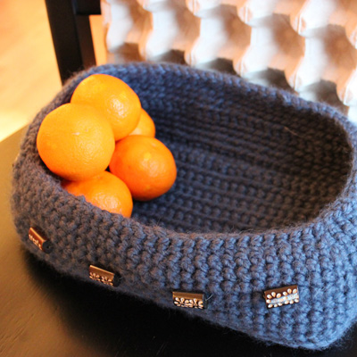 image of stormy ocean blue basket with bright orange tangerines